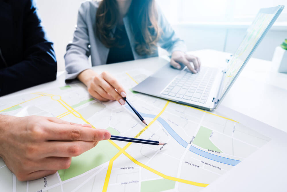 Two People Looking At City Map